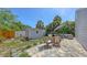 Beautiful backyard featuring a brick patio, fire pit, shed, lush landscaping, and mature trees at 2420 Webber St, Sarasota, FL 34239