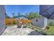 Charming backyard with a cozy fire pit, brick paver patio, and a shed surrounded by lush greenery at 2420 Webber St, Sarasota, FL 34239