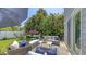 Inviting backyard patio with comfortable seating, an umbrella, and lush tropical landscaping at 2420 Webber St, Sarasota, FL 34239