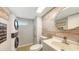 Modern bathroom with stackable washer and dryer, decorative mirror, and wood accent wall at 2420 Webber St, Sarasota, FL 34239