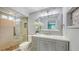 Bright bathroom with a shower, vanity, sink, mirror and a neutral color palette at 2420 Webber St, Sarasota, FL 34239