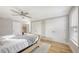 Bright bedroom with a ceiling fan, hardwood floors, natural light, white walls and closets for storage space at 2420 Webber St, Sarasota, FL 34239