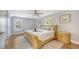Bright bedroom featuring a decorative ceiling fan, artwork, and natural light at 2420 Webber St, Sarasota, FL 34239