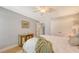 Bright bedroom featuring a wooden four-poster bed, hardwood floors, and soft lighting at 2420 Webber St, Sarasota, FL 34239
