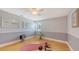 Well-lit bedroom featuring a hardwood floor, yoga mat, bright window, and neutral-colored walls at 2420 Webber St, Sarasota, FL 34239