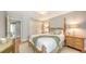 Cozy bedroom featuring a wooden four-poster bed, hardwood floors, and soft lighting at 2420 Webber St, Sarasota, FL 34239