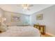 Comfortable bedroom featuring a wooden four-poster bed, hardwood floors, and soft lighting at 2420 Webber St, Sarasota, FL 34239