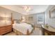 Charming bedroom featuring a wooden four-poster bed, hardwood floors, and soft lighting at 2420 Webber St, Sarasota, FL 34239