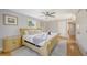 Bright bedroom with natural light, hardwood floors and a light wood sleigh bed and a ceiling fan at 2420 Webber St, Sarasota, FL 34239
