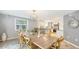 Dining room with a large wood table and kitchen view, offering a bright, open space at 2420 Webber St, Sarasota, FL 34239