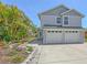 Charming two-story home features a manicured lawn, a two-car garage, and lovely landscaping at 2420 Webber St, Sarasota, FL 34239