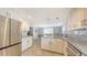 Bright kitchen with granite countertops open to the dining room at 2420 Webber St, Sarasota, FL 34239