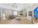Spacious living room with a charming fireplace, tile flooring, and ample seating at 2420 Webber St, Sarasota, FL 34239