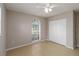 Bright bedroom featuring tile floors, a window and a ceiling fan with lights at 2662 6Th E Ct, Ellenton, FL 34222