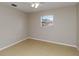 Cozy bedroom with neutral walls, tile flooring, and a window at 2662 6Th E Ct, Ellenton, FL 34222