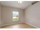 Bright bedroom featuring tile floors and a window overlooking green space at 2662 6Th E Ct, Ellenton, FL 34222
