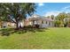 Exterior view of the house showcasing the well-maintained lawn and lush landscaping at 2662 6Th E Ct, Ellenton, FL 34222