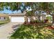 Charming single-story home featuring a well-manicured lawn, mature trees, and a two-car garage at 2662 6Th E Ct, Ellenton, FL 34222