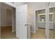 Hallway with neutral walls that leads to the bathroom with ample vanity space at 2662 6Th E Ct, Ellenton, FL 34222