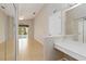 Bright hallway showing view of pool and vanity with sliding closet doors at 2662 6Th E Ct, Ellenton, FL 34222