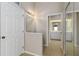 Hallway with mirror closet doors leading to a bathroom with a large vanity at 2662 6Th E Ct, Ellenton, FL 34222