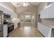 Open kitchen with white cabinetry, stainless steel appliances, and a view to the backyard at 2662 6Th E Ct, Ellenton, FL 34222