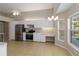 Open kitchen featuring white cabinets, stainless steel appliances, and a breakfast nook with bay windows at 2662 6Th E Ct, Ellenton, FL 34222