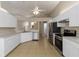 Modern kitchen with white cabinets, stainless steel appliances, and tiled floor at 2662 6Th E Ct, Ellenton, FL 34222