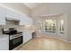 Well-equipped kitchen with white cabinets, stainless steel appliances, and a window overlooking the pool at 2662 6Th E Ct, Ellenton, FL 34222