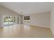 Open living room featuring tile flooring, sliding doors to the patio, and natural light at 2662 6Th E Ct, Ellenton, FL 34222
