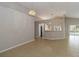 Open-concept living room with tile flooring and a view of the adjacent kitchen at 2662 6Th E Ct, Ellenton, FL 34222