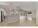 Spacious living area with tile flooring, leading to a sliding glass door and dining area at 2662 6Th E Ct, Ellenton, FL 34222