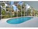 Relaxing screened-in pool surrounded by lush greenery and bright skies at 2662 6Th E Ct, Ellenton, FL 34222