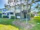 Well-maintained backyard with mature landscaping, a black fence, and a screened-in lanai at 30073 Southwell Ln, Wesley Chapel, FL 33543