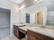 Bathroom features double sinks, marble countertops, tile floors, and a mirror at 30073 Southwell Ln, Wesley Chapel, FL 33543