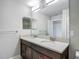 Bathroom vanity featuring double sink, marble countertop, and large vanity mirror at 30073 Southwell Ln, Wesley Chapel, FL 33543