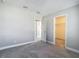Bedroom with neutral walls, carpet flooring, and doorways to closet and other rooms at 30073 Southwell Ln, Wesley Chapel, FL 33543