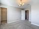 A well-lit bedroom with walk-in closet and neutral gray walls and carpet at 30073 Southwell Ln, Wesley Chapel, FL 33543