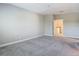 An airy bedroom featuring neutral walls, carpet flooring, and an open doorway at 30073 Southwell Ln, Wesley Chapel, FL 33543