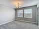 A bright bedroom featuring two windows and neutral gray walls and carpet at 30073 Southwell Ln, Wesley Chapel, FL 33543