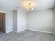 An airy room bathed in light, featuring a neutral palette and plush gray carpeting at 30073 Southwell Ln, Wesley Chapel, FL 33543