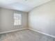 An airy bedroom featuring neutral walls, carpet flooring, and a window at 30073 Southwell Ln, Wesley Chapel, FL 33543