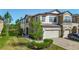 Townhome featuring manicured lawn and landscaping, covered entryway and two-car garage at 30073 Southwell Ln, Wesley Chapel, FL 33543