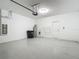 Attached two car garage with water heater, garage door opener, storage shelves, and additional storage at 30073 Southwell Ln, Wesley Chapel, FL 33543
