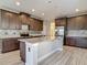 Spacious kitchen with stainless steel appliances, a tile backsplash, and a large island at 30073 Southwell Ln, Wesley Chapel, FL 33543