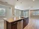 Modern kitchen island featuring sink, dishwasher, and attractive wood cabinetry at 30073 Southwell Ln, Wesley Chapel, FL 33543