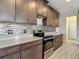 Modern kitchen with stainless steel appliances, stylish backsplash and attractive cabinets at 30073 Southwell Ln, Wesley Chapel, FL 33543