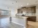 Open kitchen with large island, stainless appliances, tile backsplash and plenty of cabinet space at 30073 Southwell Ln, Wesley Chapel, FL 33543