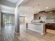 Open concept kitchen with dark cabinets, stainless steel appliances, and an island with a sink at 30073 Southwell Ln, Wesley Chapel, FL 33543