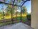 Relax on the screened lanai overlooking the backyard, perfect for outdoor seating and peaceful moments at 30073 Southwell Ln, Wesley Chapel, FL 33543